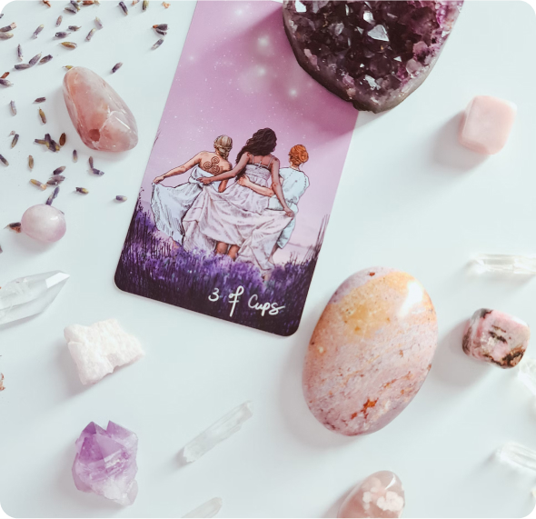 tarot card on a white table surrounded by lavender and crystals
